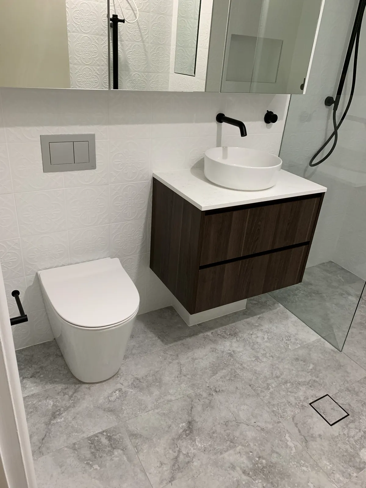 Marble bathroom with black tapware