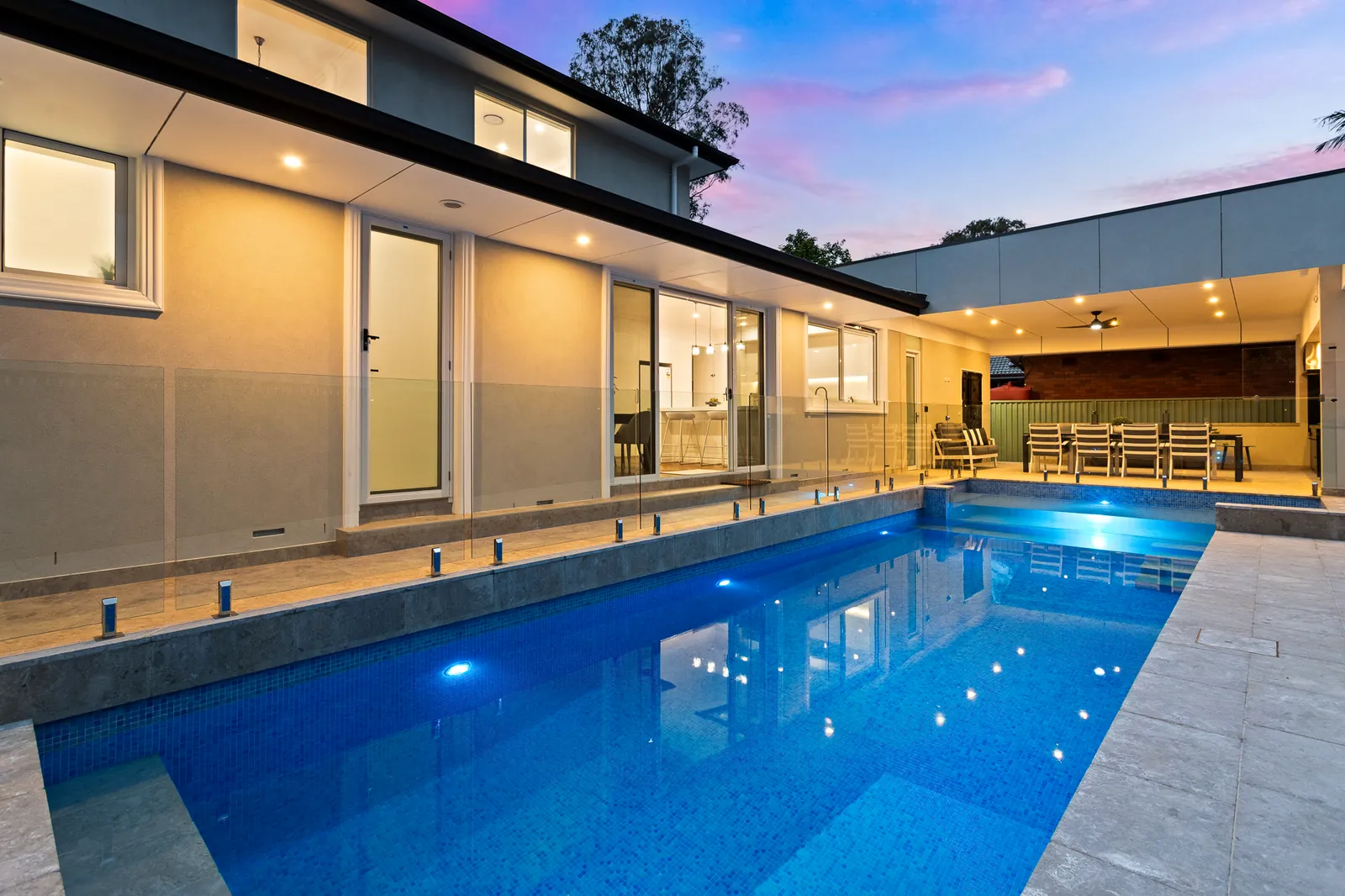 Pool and rear elevation at dusk